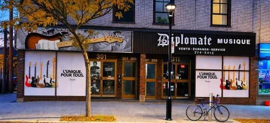 Vitrines du magasin Diplomate Musique avec graphiques de guitares